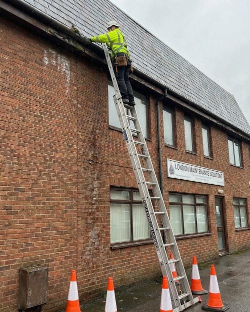 Trade extension ladder positioned against a residential building for exterior repair and access work. Extension Ladder Hire London with Hireload.