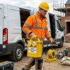 5kVA 110V Site Transformer Hire London 15 Worker in hard hat unloading 5kVA 110V site transformer from delivery van on construction site