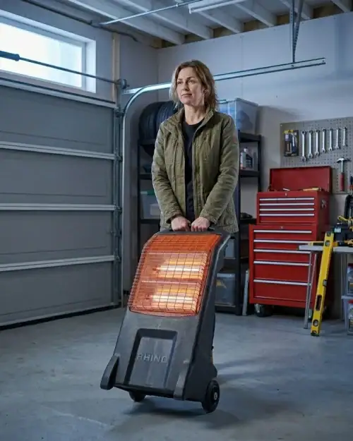 Infrared Heater Hire London | 3kW Radiant Heater on Tripod (240V) 7 Infrared heater hire London – Rhino 3kW infrared heater in use in a garage workshop environment