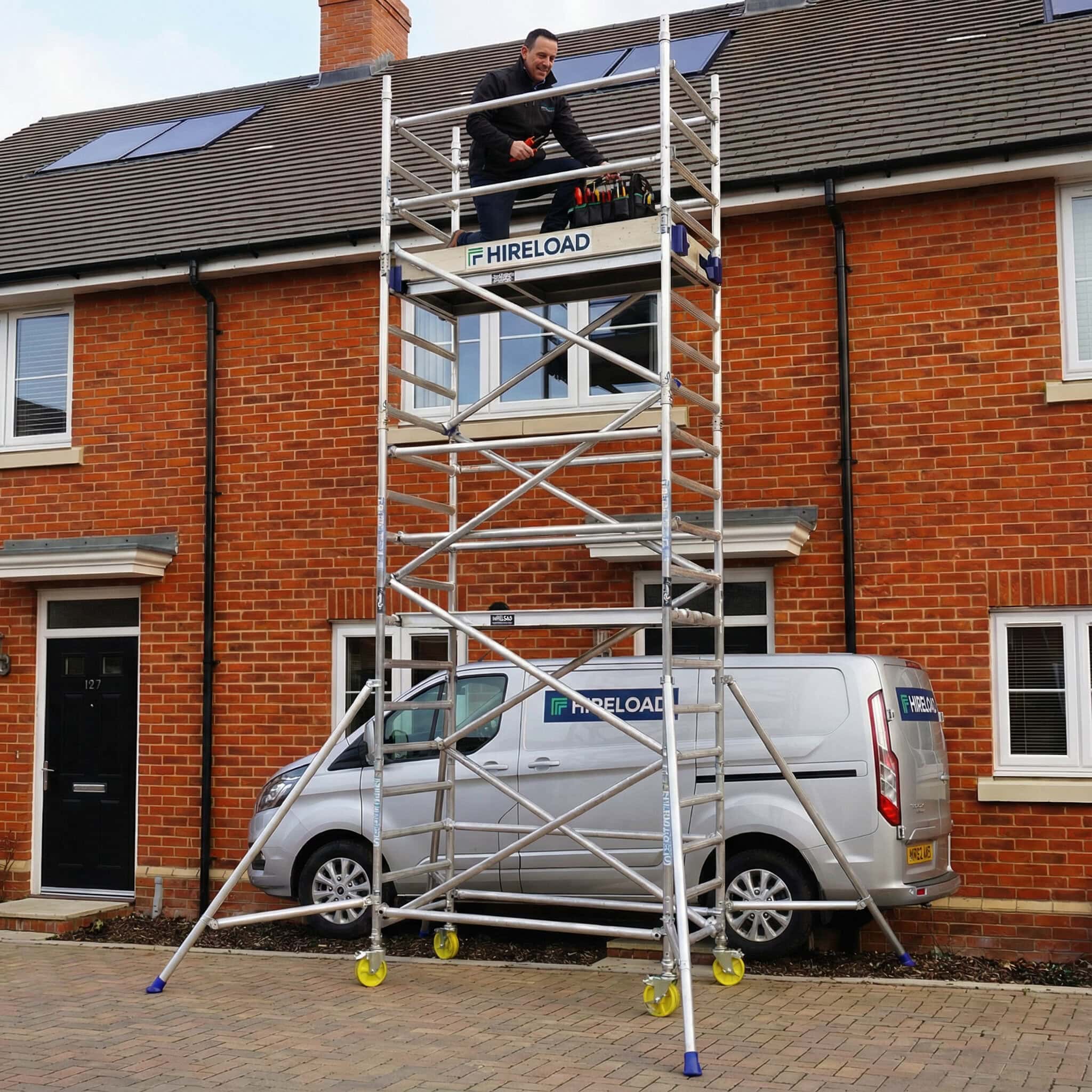 Industrial Scaffold Tower Hire (Single 0.85cm×1.8m) 2 Scaffold tower hire London with worker on elevated platform accessing residential roof and gutters
