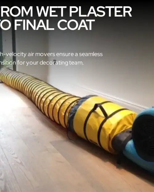 Air mover hire London – ducting hose from air mover directed into wall cavity on active construction site