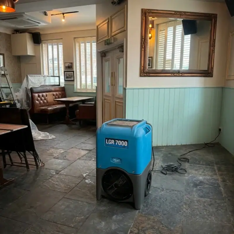 Rising Damp vs Condensation vs Penetrating Damp: How to Tell the Difference 12 Industrial dehumidifier drying package set up inside a pub for commercial water damage drying hire London