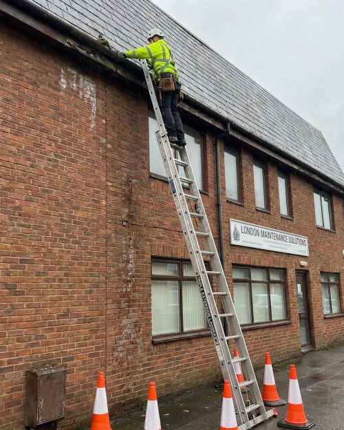 Trade extension ladder positioned against a residential building for exterior repair and access work. Extension Ladder Hire London with Hireload.