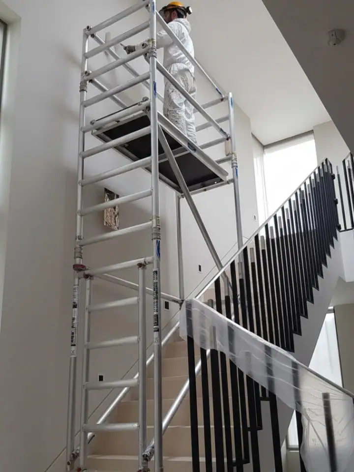 Stairwell Scaffold Tower Hire 2 Stairwell scaffold tower hire in use for painting and decorating above a residential staircase