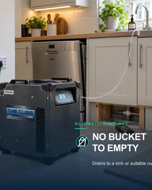 Dri-Eaz Cube pumping condensate through its drain hose into a kitchen sink, with no bucket to empty